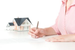 Woman confirm mortgage contract (estate agency client sign contract)